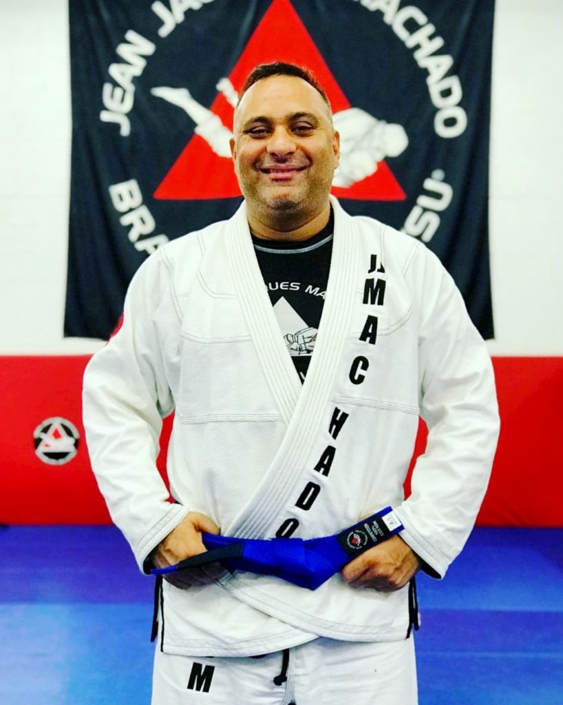 Celebrity Russel Peters showing off his blue belt after being promoted