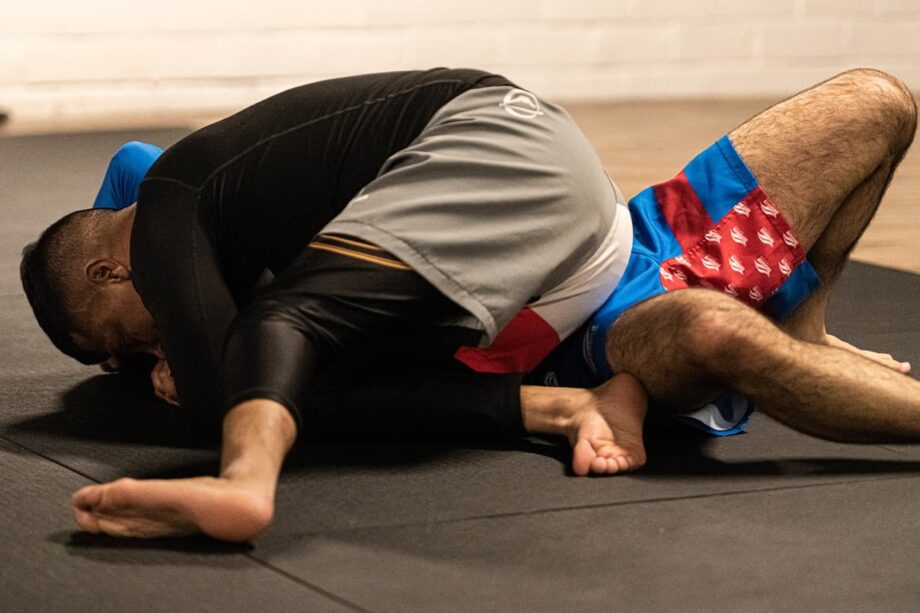 Two people training jiu jitsu